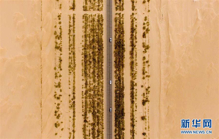 (壯闊東方潮奮進新時代——慶祝改革開放40年)(1)公路在“死亡之海”里延伸